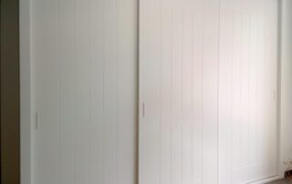 A room with a bed and a door.
